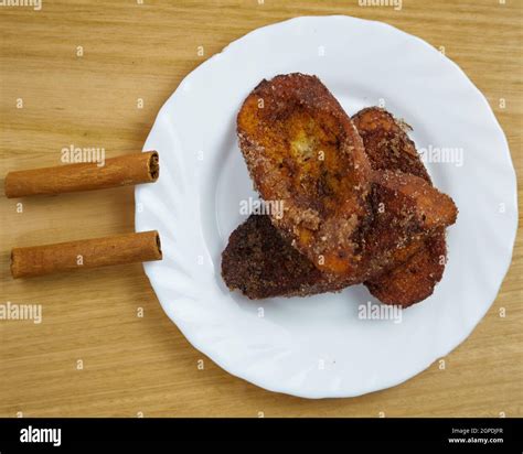 Traditional homemade Spanish Torrijas in a white dish decorated with ...