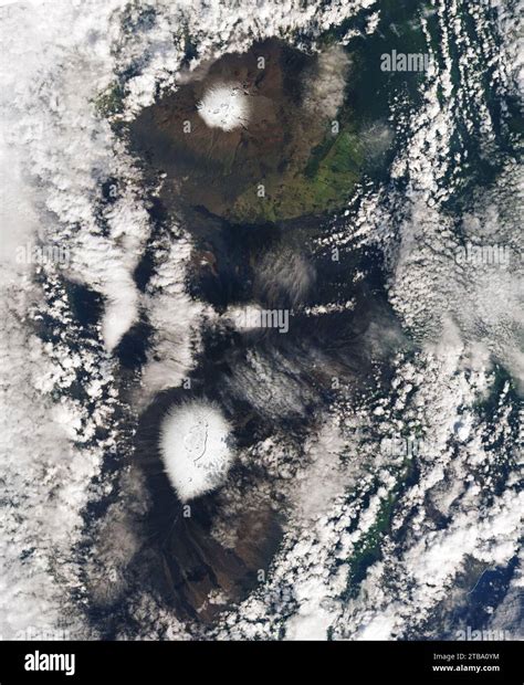 Snow on the peaks of Mauna Kea and Mauna Loa, Hawaii, from a low-pressure Kona storm Stock Photo ...