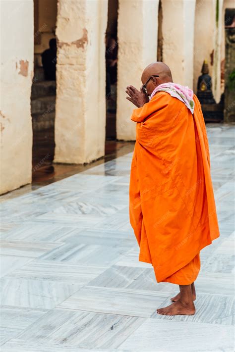 Premium Photo | Indian Buddhist monk standing and praying on bare foot ...