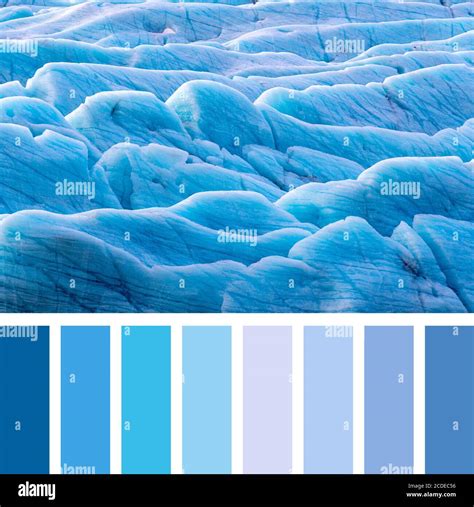 Sunlight catches the edges of blue glacial ice at the Svinafellsjokul ...