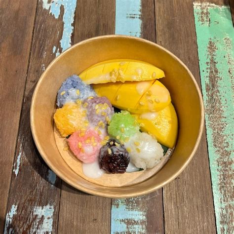 A bowl of fruit with a banana and other fruit in it. | Premium Photo