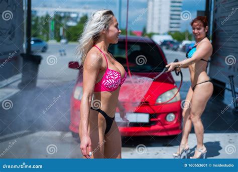 Luxury Girls in Seductive Bikinis Wash a Car in a Street Car Wash and ...