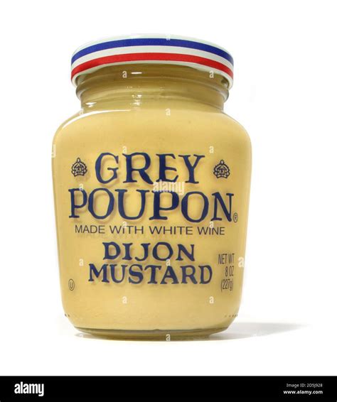 A closed jar of grey poupon dijon mustard photographed on a white ...