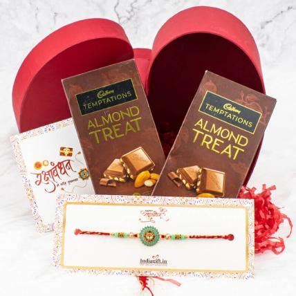 Send Round pearl rakhi with Almond and chocolates in heart shape box ...