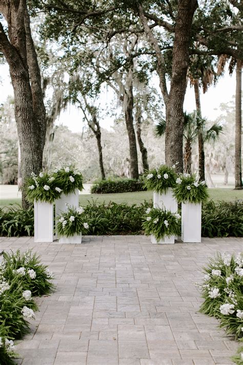 White Wooden Pillars | Outdoor wedding altars, Wedding alter flowers ...