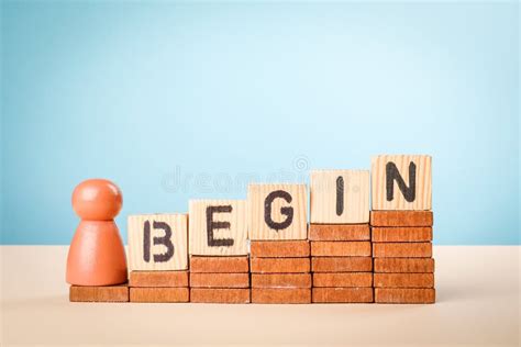 The Word BEGIN Spelled Out with Alphabet Blocks on Wooden Steps ...