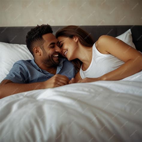 Portrait of happy couple lying in bed and laughing | Premium AI ...