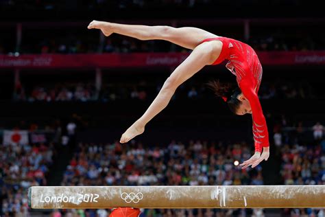 Download Gymnast Perfecting Her Balance Beam Routine | Wallpapers.com