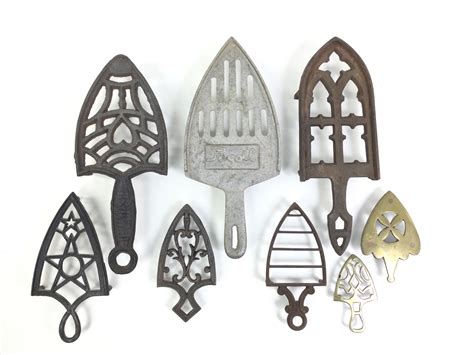 Lot - (8) Cast Metal Sad Iron Trivets