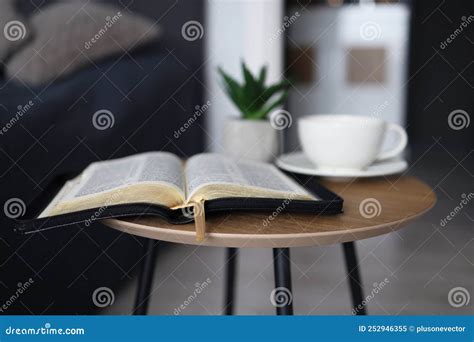 Open Bible with a Cup of Tea on a Wooden Table in the Bedroom. Time for ...