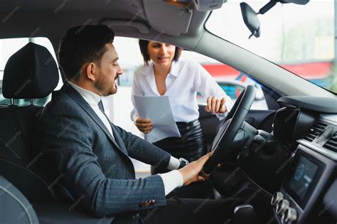 Premium Photo | Salesperson selling cars at car dealership