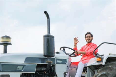 Indian farmer working with tractor at field | Premium Photo