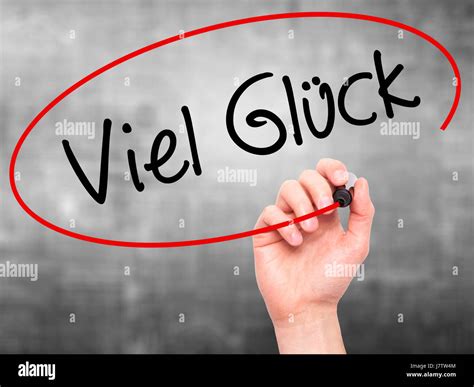 Man Hand writing Viel Gluck (Good Luck in German) with black marker on ...