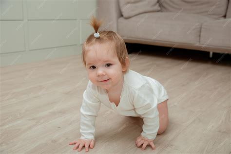 Premium Photo | A baby girl crawling on the floor