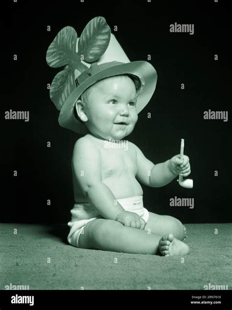 1950s BABY SITTING WEARING ST. PATRICK’S DAY HAT WITH SHAMROCK AND ...