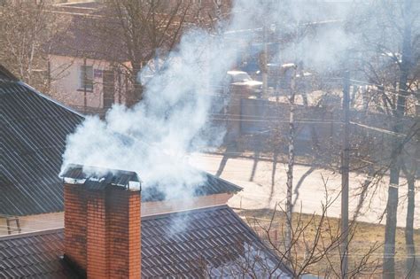 Smoke comes out of the chimney of a modern house the topic of the gas ...