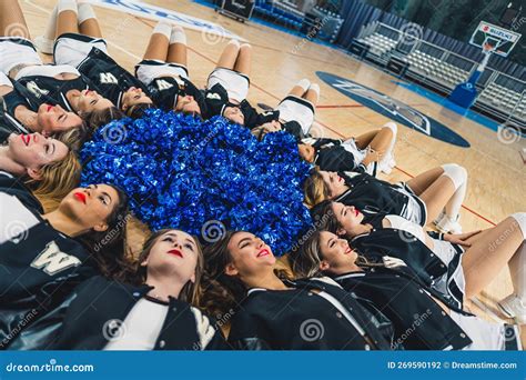 Pretty Cheerleaders Laying on the Floor Ina Circle, Blue Pom-poms in ...