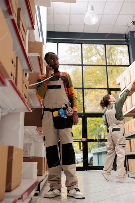 Premium Photo | Storehouse employee explaining delivery details to ...