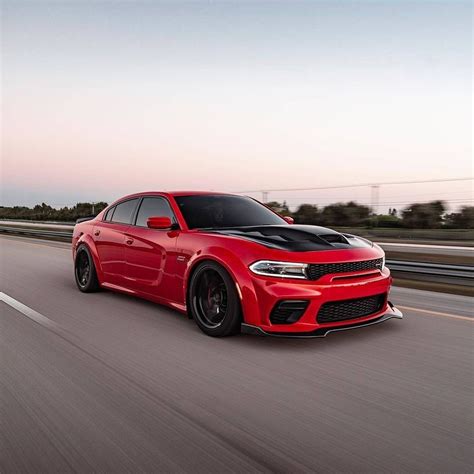 Red Dodge Charger Racing Down the Road