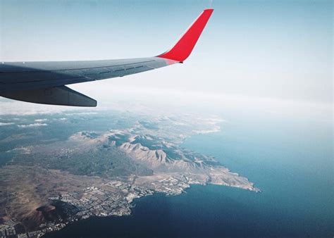 Aerial view of airplane flying over sea against sky | Premium Photo