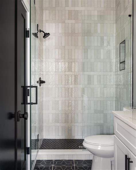 Cloe White Shower Tile with Makoto Black Rounds - Bathroom Remodel Inspiration