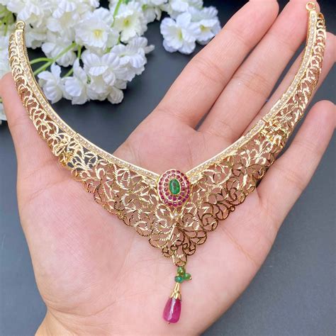 Intricately Carved Gold Necklace Set studded with precious stones GNS