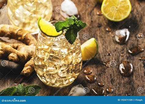 Golden Ginger Ale Beer Cocktail with Lime, Lemon and Mint in Glass on ...