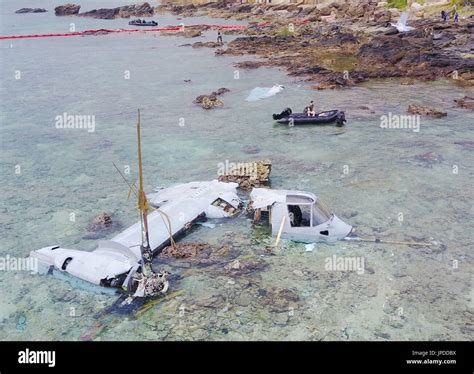 U.S. military personnel recover the wreckage of an MV-22 Osprey ...