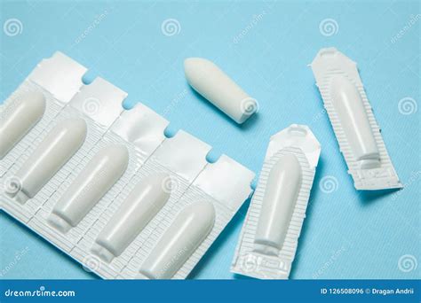 Supositorio Para El Uso Anal O Vaginal En Un Fondo Azul Velas Para El Tratamiento De Hemorroides ...