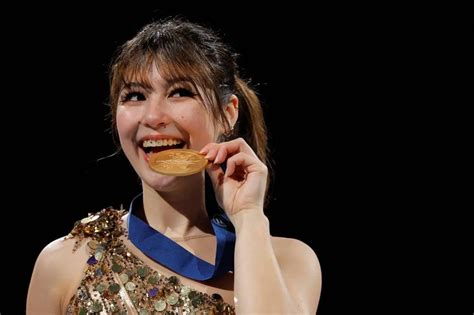 Feb 19, 2026; Milan, Italy; Alysa Liu of the United States celebrates with the gold medal in the women's free skate during the Milano Cortina 2026 Olympic Winter Games at Milano Ice Skating Arena. Mandatory Credit: James Lang-Imagn Images