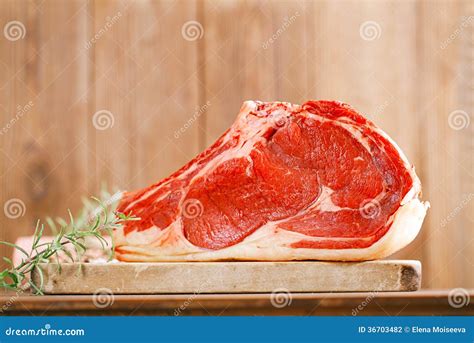 Raw Beef Rib Steak with Bone on Wooden Board Stock Photo - Image of ...