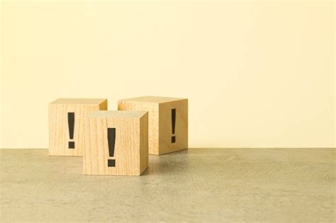 Exclamation marks are written on wooden blocks blocks are located on a ...