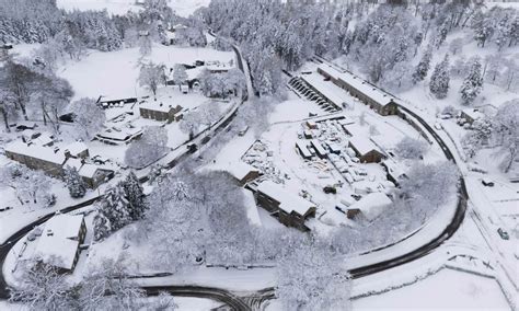 UK weather live: Snow causes school closures as flood warnings issued