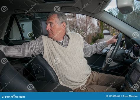 Senior Man Backing Up in Car Stock Photo - Image of turning, drive ...