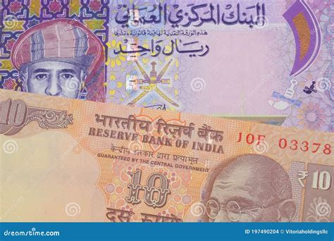 A Orange Ten Rupee Bill from India Paired with a Colorful One Rial Note Note from Oman. Stock ... - currency of oman in indian rupees