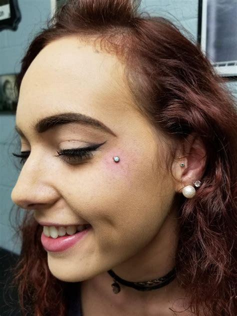 This beauty is so happy to have her new facial piercing: cheek dermal ...