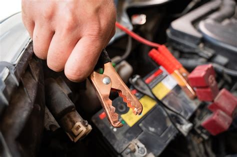 Cropped hand of man repairing car engine | Premium Photo