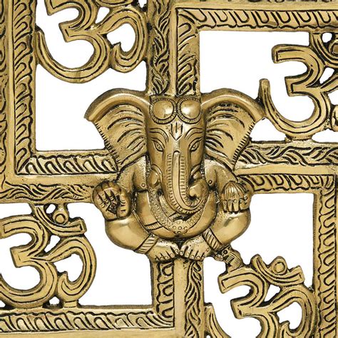 Wall hanging swastik with om and ganesh motiff in metal antique golden ...