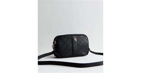 Black Debossed Monogram Cross Body Camera Bag | New Look