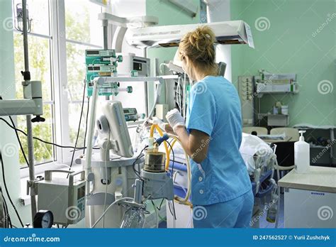 At the Intensive Care Unit. Nurse Standing Near Hospital Bed with a ...