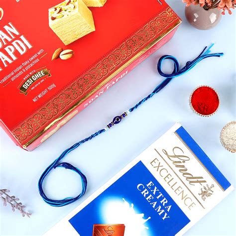 Send Evil Eye Rakhi with Soan Papdi & Lindt Online