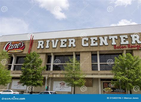 Raising Canes River Center with Lush Green Trees and Parked Cars on the ...