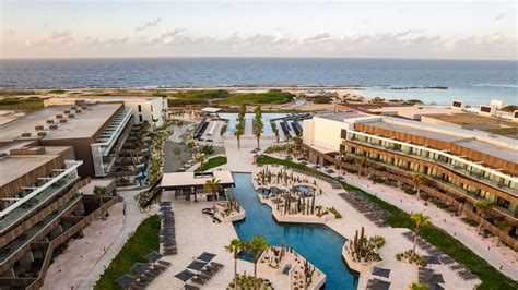 https://media.cntraveler.com/photos/6942f42eeac99b620c8d8ed9/16%3A9/w_2560%2Cc_limit/Secrets-Aruba-SEAUA-EXT-Main-Pool-11-CP.jpg