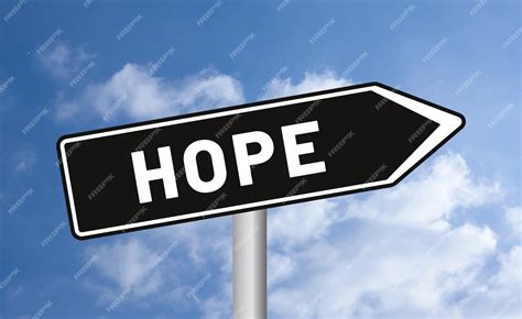 Premium Photo | Hope road sign on cloudy sky background