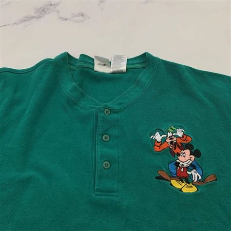 The Disney Store men's vintage green henley shirt... - Depop