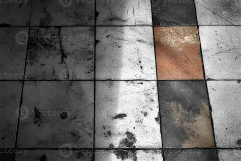 Detailed view of an old tile floor texture with shadows creating an ...