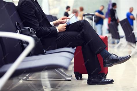 Businessman using digital tablet in airport departure lounge | Premium ...