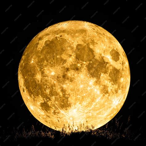 Premium Photo | A large yellow moon is the main focus of the image