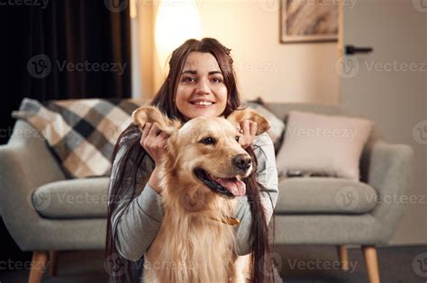 Playing, with ears, front view, portrait. Woman is with golden ...