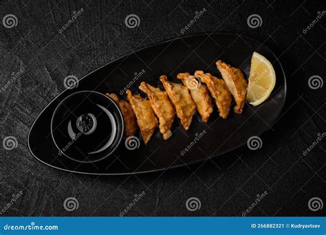 Japanese Pan-fried Gyoza or Dumplings Snack on Black Background Stock ...